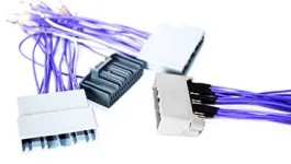 Several wiring harnesses with purple wires and gray or white plastic connectors are spread out on a white surface.