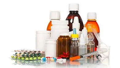 Assorted medications, including pill bottles, liquid medicine, blister packs, and a syringe, displayed on a white background.
