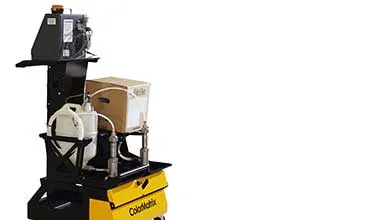 Mobile ColorMatrix dispensing system on wheels with integrated control unit, pump, tubing, and material container.