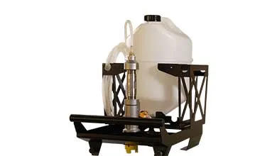 A white plastic fluid tank in a black metal frame is connected by a clear tube to a vertical metal-and-glass flow meter at the front.