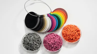 Circular color samples arranged in a ring with containers of matching plastic pellets.
