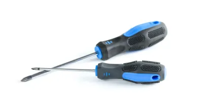 Two screwdrivers with black and blue handles placed on a white surface.