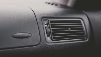 Close‑up of a car dashboard air vent and textured interior trim.